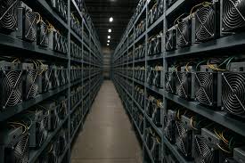 Rows of cryptocurrency mining rigs inside a professional hosting facility data center